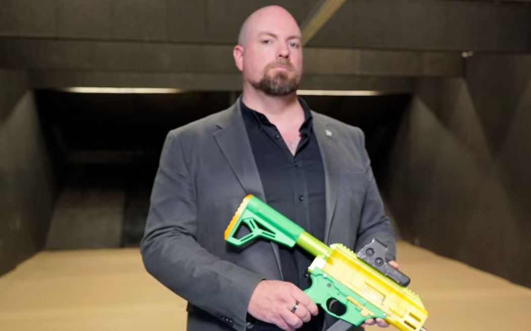 Australian Federal Police forensics co-ordinator Michael Taylor holds a 3D-printed gun.