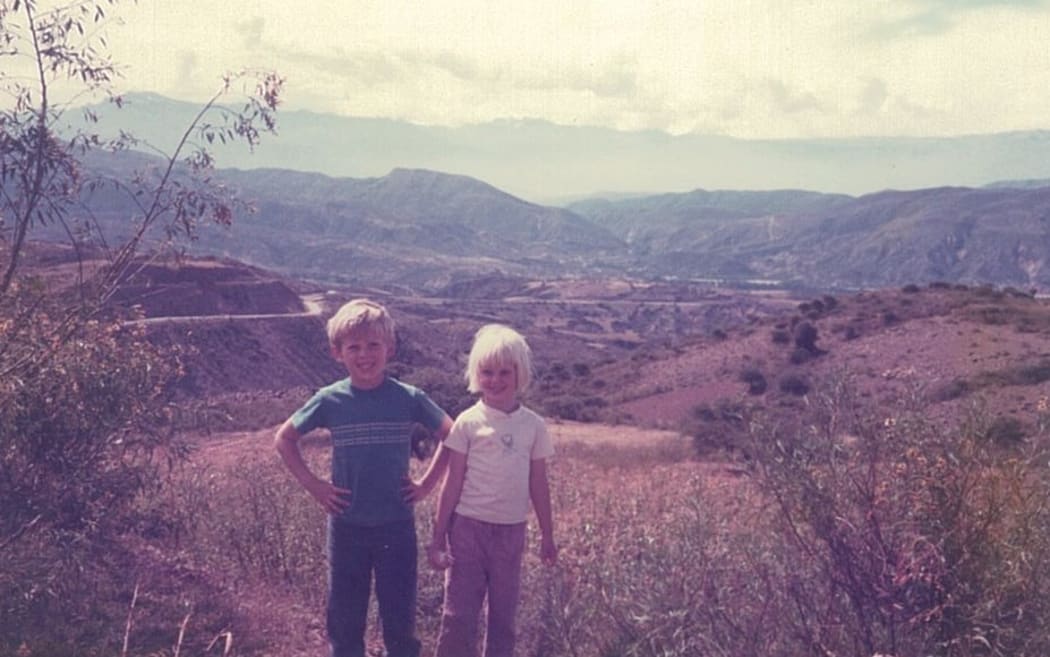 Libby Kirkby-McLeod and her brother in Bolivia. Cochabamba lies between the first set of hills and those on the horizon, the road going through a small pass can just be seen in the middle.