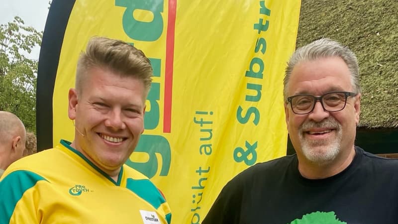 Herbi Managing Director Frank Lachmann (black t-shirt) and Christian Mauck (yellow t-shirt) from Floragard in Germany together at a garden convention in 2024 when Herbi SOIL - Living Soil Growing mix was launched in Europe after it was developed by Frank at our Taranaki backyard.