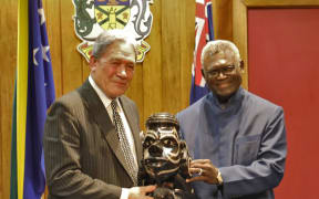 Solomon Islands prime minister (right) Manasseh Sogavare presents a Nguzu Nguzu to New Zealand's deputy prime minister Winston Peters. June 2019