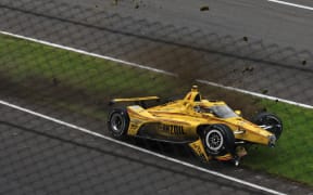 Scott McLaughlin's Team Penske car lies wrecked on the side of the Indianapolis 500 track after he crashed before the race started. 26 May 2025.