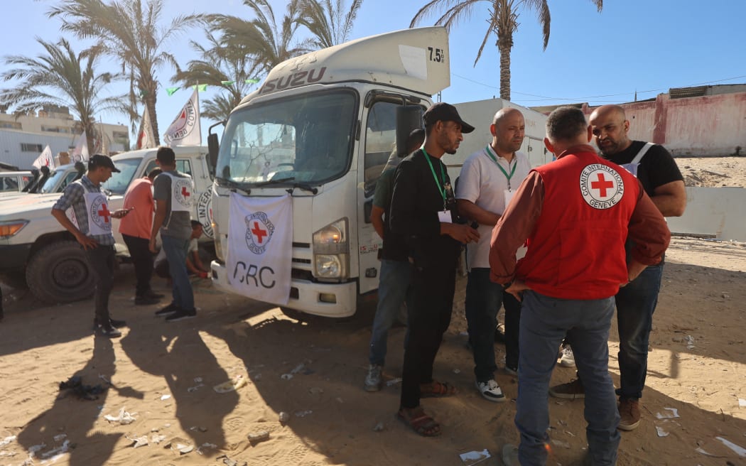 Red Crescent vehicles and refrigerated trucks are parked at the Nasser hospital in Khan Yunis in the southern Gaza Strip on 15 October, 2025, after transporting the bodies of Palestinians that had been in Israeli custody. Under the ceasefire deal brokered by the US president, Israel was to turn over the bodies of 15 Palestinians for every deceased Israeli returned.