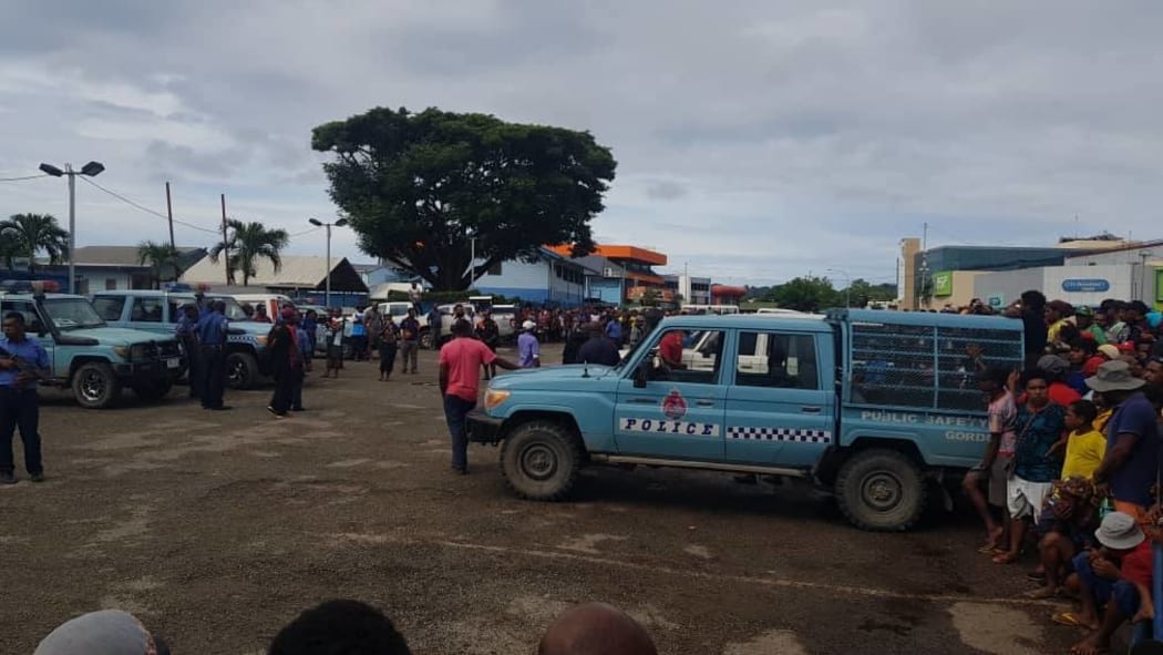 Police contain the crowd gathered at Boroka station.