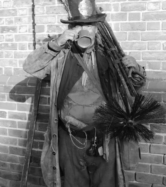 17435964 - victorian chimney sweep wearing his old clothes & carrying his brush