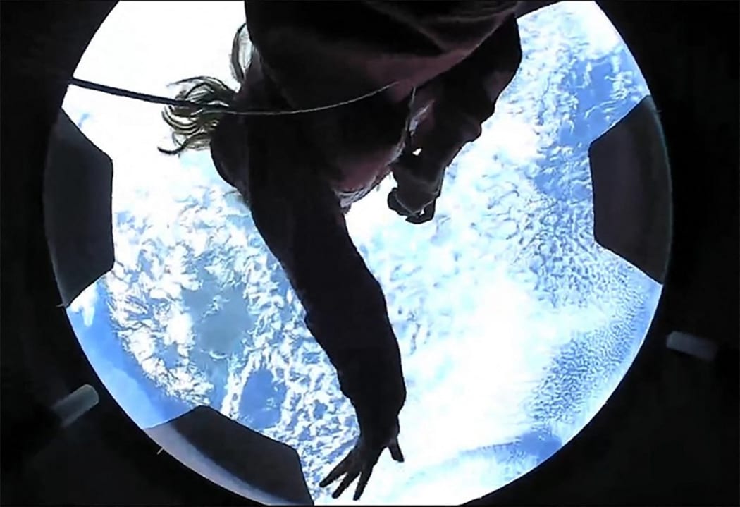 This September 16, 2021, image courtesy of Inspiration4 shows the Inspiration4 crew member Hayley Arceneaux looking out of an observation window while in orbit.