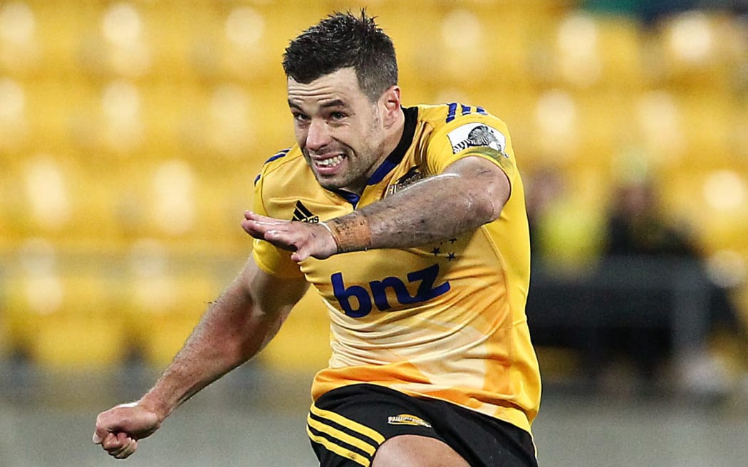 The Hurricanes' James Marshall kicks a penalty.