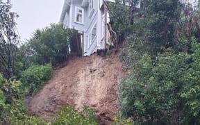 A slip on Laura Avenue in the Wellington suburb of Brooklyn blocks the road and undermines part of a house.