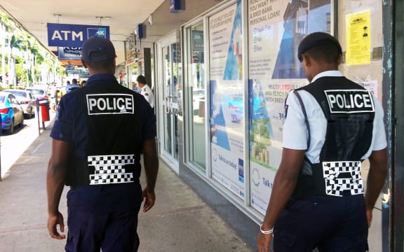 70710201 - lautoka, fiji -  dec 30 2016:fijian police officers patrolling in the main street. the fiji police force annual statistics reveal an 18% increase in crime cases in 2015.