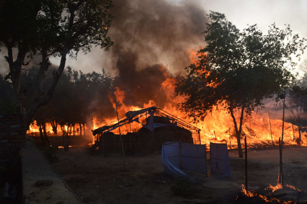 Former homes of Indian members of a sect burn following clashes with police during an eviction at the Jawahar Bagh park in Mathura on June 2, 2016.