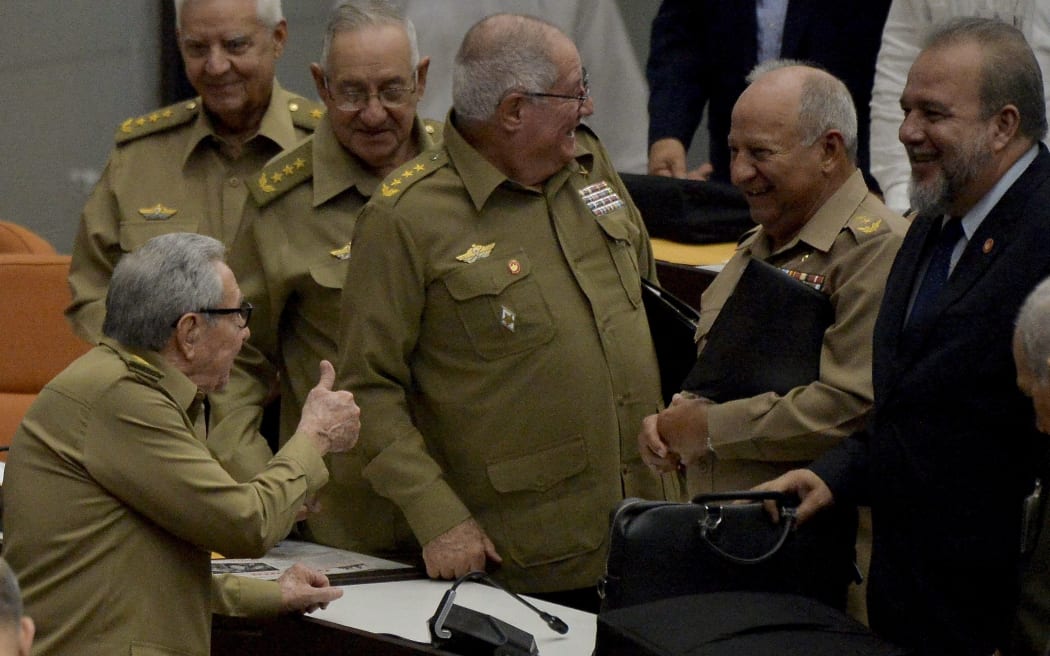 Cuban First Secretary of the Communist Party Raul Castro (L), gives the thumb up to newly appointed Prime Minister Manuel Marrero Cruz (R) and deputies, during the closing of the Fourth Regular Session of the National Assembly of Popular Power in Havana