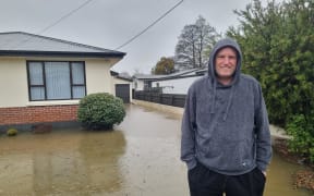 Gore resident Justin White arrived home to find his front yard flooded, some parts are 30 centimetres or more deep. He says there is sewage floating in it.