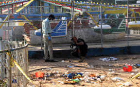 Pakistani security officials collect evidence at the cordoned-off site of the March 27 suicide bombing, in Lahore on March 28, 2016.