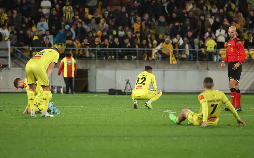 The Phoenix players sit dejected after their loss during the A-League Men’s Semi Final against Melbourne Victory, 2024.