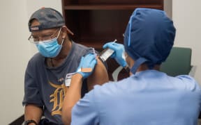 In this file image courtesy of the Henry Ford Health System, volunteers are given the Moderna mRNA-1273 Coronavirus Efficacy (COVE), on 5 August, 2020, in Detroit, Michigan.