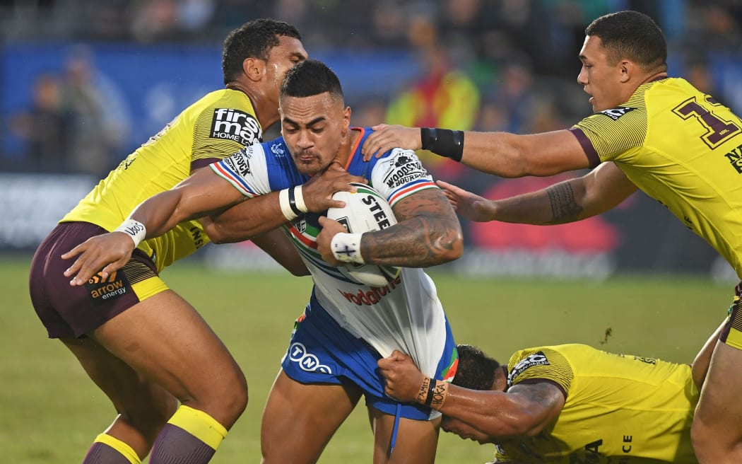 Warriors wing Ken Maumalo carries the ball forward against the Broncos.
