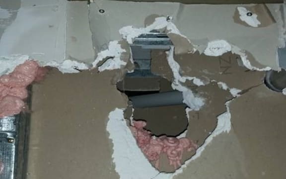 A photo of poor fire rating work that would let smoke and flames through.