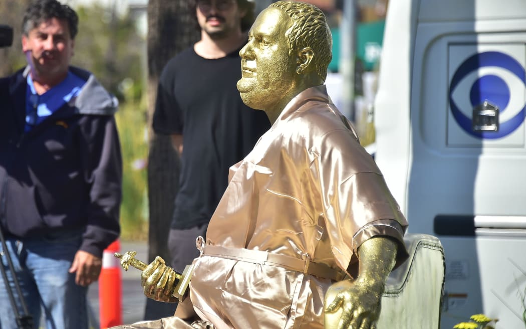 A gold sculpture of Harvey Weinstein on his infamous casting couch holding an Oscar statue is on display in Hollywood.
