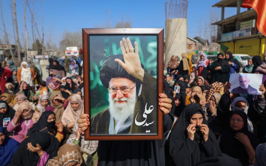 A Shiite Muslim woman holds a portrait of Iran's Supreme Leader Ayatollah Ali Khamenei during a protest against the killing of Iran's Supreme Leader Ayatollah Ali Khamenei in Shadipora, Sumbal area of Bandipora District, north of Srinagar, Jammu and Kashmir, on March 3, 2026. Authorities impose severe precautionary restrictions for the second consecutive day in parts of Kashmir to stop protesters following the killing of Iran's Supreme Leader in joint US-Israeli airstrikes. Meanwhile, new strikes are reported on March 3 across the Middle East, including Israeli bombardment on Lebanon and a drone attack on the US embassy in Saudi Arabia. The conflict starts with US and Israeli strikes on Iran on February 28, which spark retaliatory Iranian attacks across the region, and shows no sign of abating as it enters its fourth day. (Photo by Firdous Nazir/NurPhoto) (Photo by Firdous Nazir / NurPhoto via AFP)