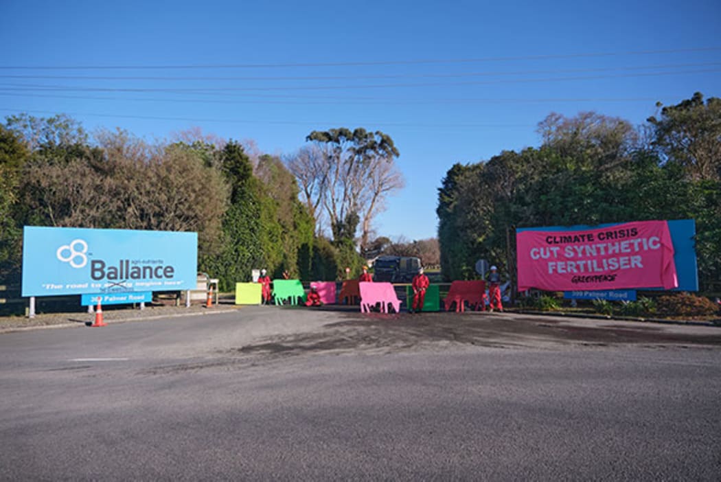 About five activists from Greenpeace and Climate Justice Taranaki have erected signs and chained themselves to material blocking the Ballance Agri Nutrients factory entrance in Kapuni.