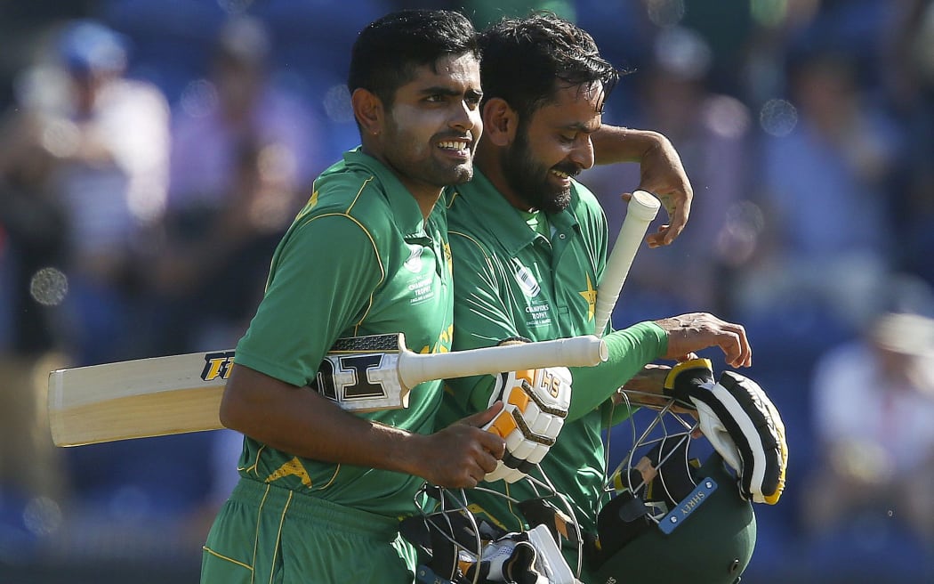 Mohammad Hafeez (R) and Babar Azam walks back to the pavilion after Pakistan won the ICC Champions Trophy semi-final cricket match between England and Pakistan.
