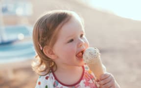 Cute little girl eating ice-cream