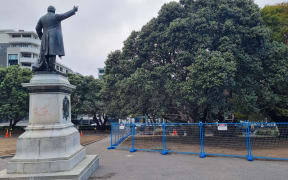 Fences remain around Parliament's lawn as it regrows and the playground is still closed off.