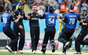 The Black Caps congratulate Trent Boult after he takes a wicket.
