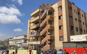 Palestinians gather outside Nasser hospital in Khan Yunis in the southern Gaza Strip following Israeli strikes.