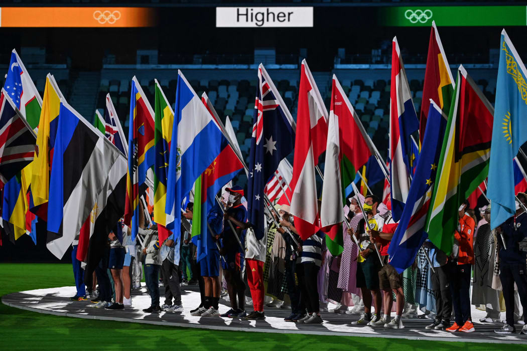 Athletes carrying nations' flags attend the closing ceremony of the Tokyo 2020 Olympic Games, at the Olympic Stadium, in Tokyo.
