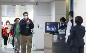 Taiwan's Center for Disease Control personnel using thermal scanners to screen passengers arriving on a flight earlier this year.