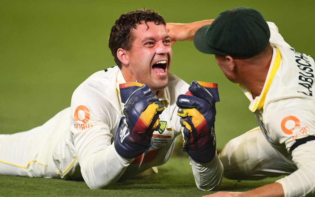 Australia wicketkeeper Alex Carey celebrates a catch.