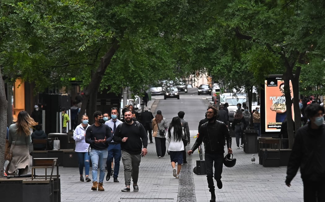 SYDNEY, AUSTRALIA - OCTOBER 12: People walk in the streets after stay-at-home orders were lifted across NSW, in Sydney, Australia, Tuesday, October 12, 2021.