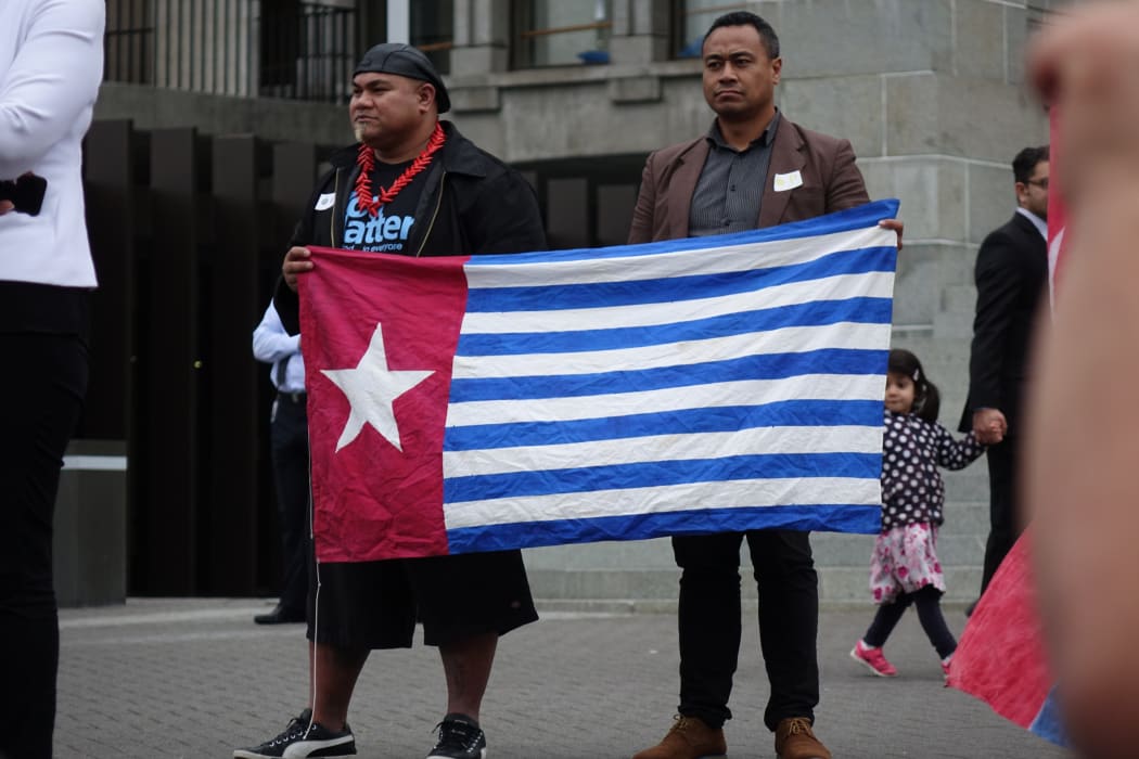 David Tua and Jerome Mika hold the West Papuan Morning Star flag outside New Zealand's parliament, 25 August, 2016.