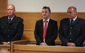 Phil Rudd (centre) at Tauranga District Court.