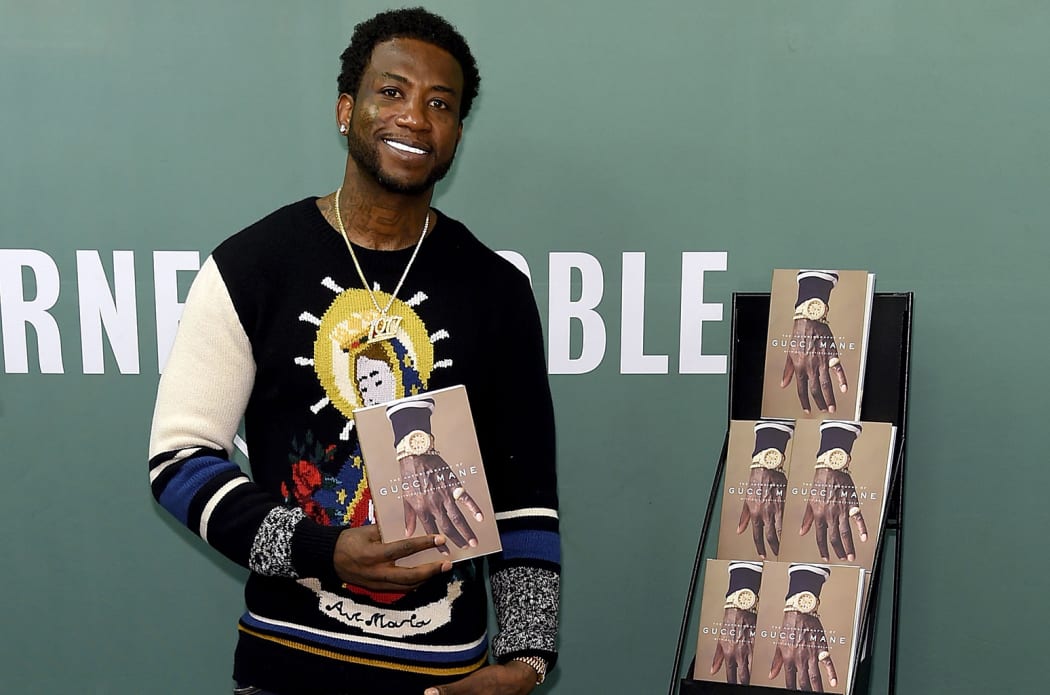 Rapper Gucci Mane with his autobiography