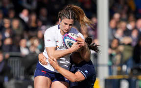 France's flanker Axelle Berthoumieu is tackled during the Six Nations international women's rugby union match between Scotland and France at The Hive Stadium in Edinburgh on March 30, 2024. (Photo by Andy Buchanan / AFP)