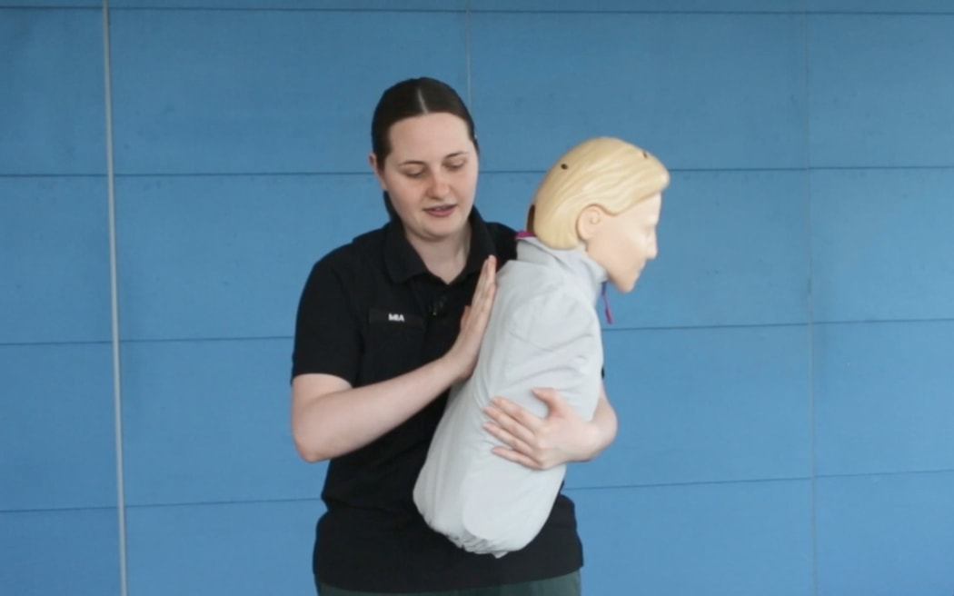 St John’s Three Steps for Life delivery lead Mia Noyes demonstrates back blows on a manikan to help someone choking.