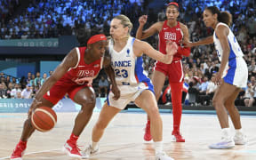 Jackie Young (USA) takes on defender Marine Johannes (France) during the Olympic women's basketball final.