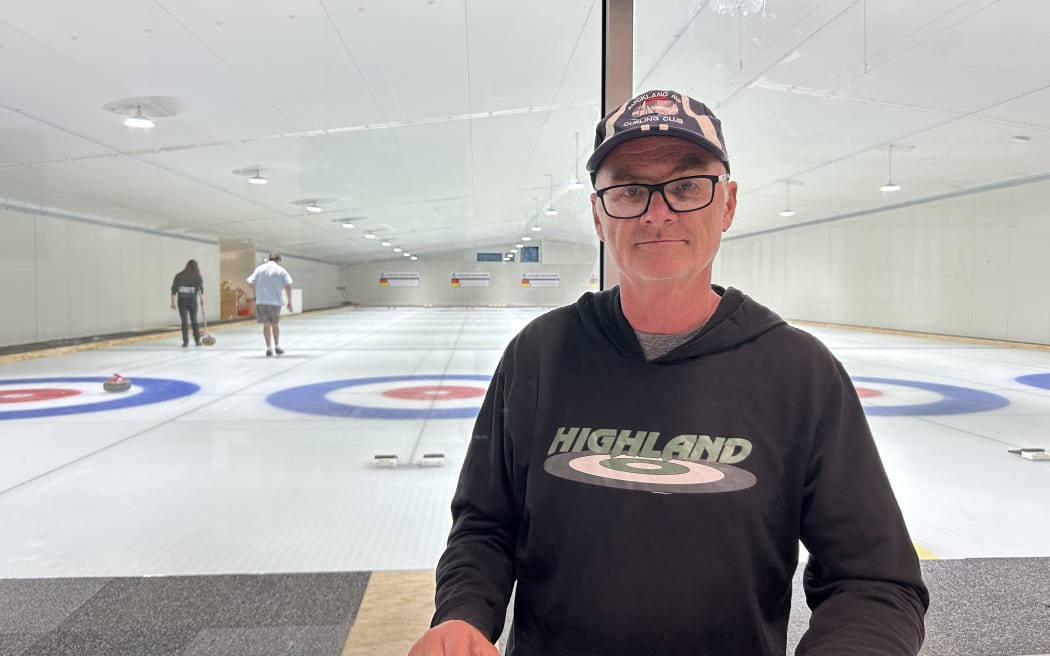 Picture shows a man standing and posing for a photo.