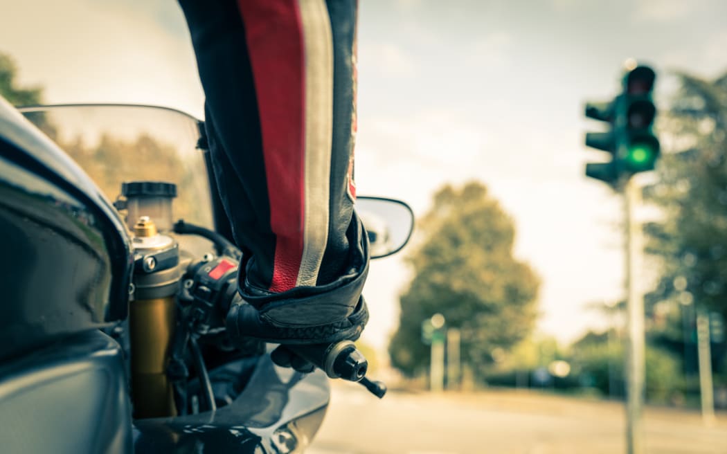 Motorcyclist on the road - Racing motorbike stops at traffic lights