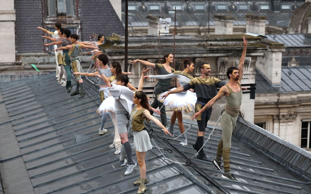 PARIS, FRANCE - JULY 26: Dancers perform on a roof during the opening ceremony of the Olympic Games Paris 2024 on July 26, 2024 in Paris, France. (Photo by Dan Mullan / POOL / AFP)