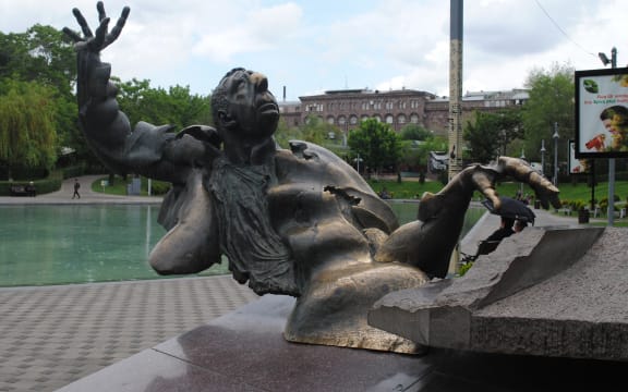 Statue of composer Arno Babajanian in Freedom Square, Yerevan. Babajanian is depicted playing the piano, leaning back, looking skywards with right hand thrust back and fingers splayed.