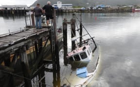 The sunken ex-fishing trawler Grace submerged at its mooring.