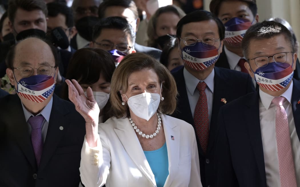 Visiting US House Speaker Nancy Pelosi (C) waves to journalists during her arrival at the Parliament in Taipei on August 3, 2022. (Photo by Sam Yeh / AFP)