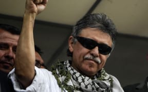 Jesus Santrich raises his clenched fist as he greets supporters after being released at the Farc headquarters in Bogota in 2019.