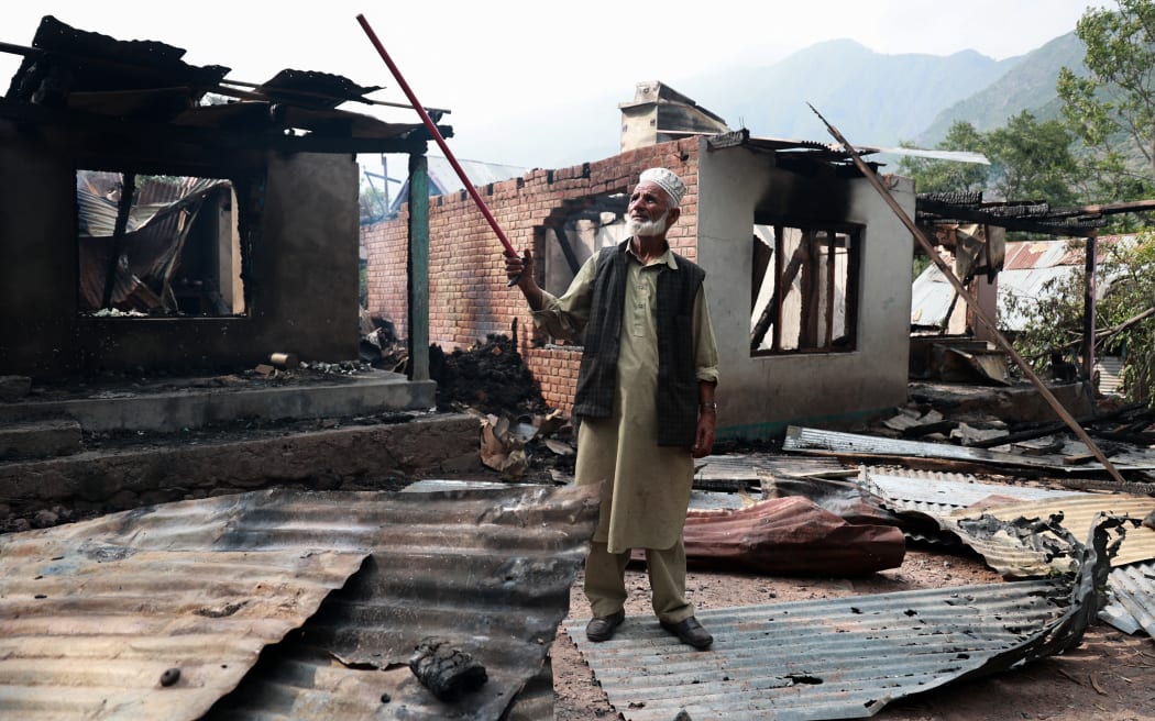Lal Din, 72, shows the location from which the mortar shell comes and hits Sultan Mohammad Naik's house in Kamalkote, Uri, Jammu and Kashmir, India, on May 7, 2025. Many civilians are injured on the Indian side after their house is hit by Pakistani shelling in Baramulla district. The Indian military says early Wednesday it launches strikes against Pakistan in retaliation for last month's militant attack in Pahalgam, Jammu and Kashmir. (Photo by Nasir Kachroo/NurPhoto) (Photo by Nasir Kachroo / NurPhoto / NurPhoto via AFP)