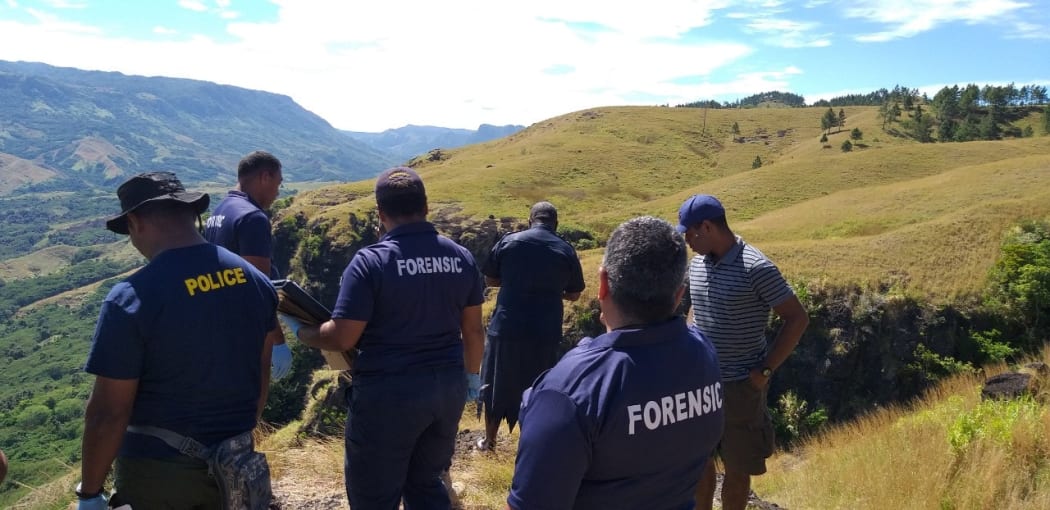 Police investigators in the Nausori Highlands following the deaths of  five members of the same family.