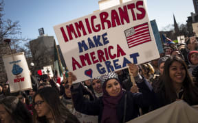 Protestors march in opposition to President Trump's executive order temporarily banning visa holders from seven Muslim-majority countries.