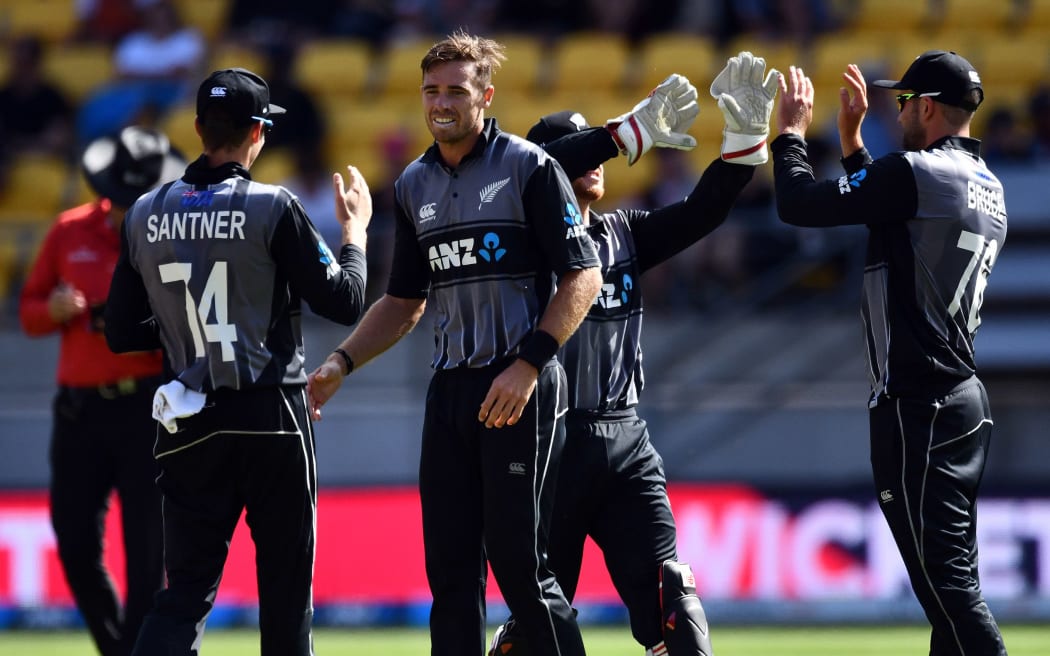 New Zealand players celebrate a wicket.