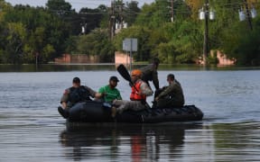Military and State Troopers help evacuate a man beside the spillway area of the Barker Reservoir in the Coldine area after Hurricane Harvey caused widespread flooding.